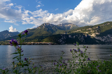 View of Lake Como and the mountains with cloudy sky - obrazy, fototapety, plakaty