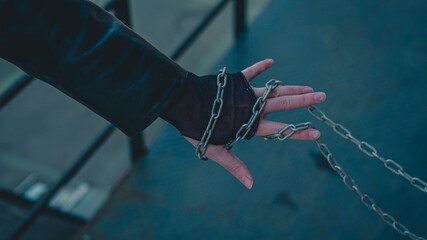 Hand holds chain in grunge style