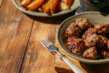 meatballs and potatoes on a wooden background