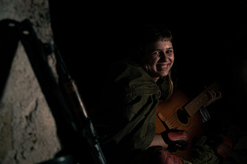 Fototapeta premium Stalker woman playing a guitar