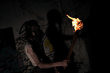 A monster in mask with torch