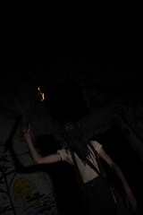A monster in mask with torch