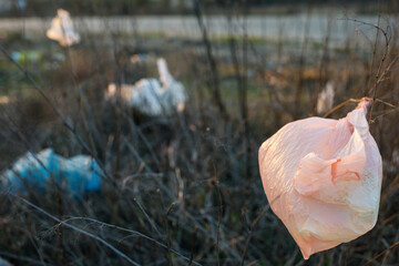 Used plastic bags are lying by the road
