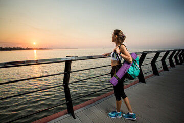 Fitness sport model in fashion sportswear with sunrise sky