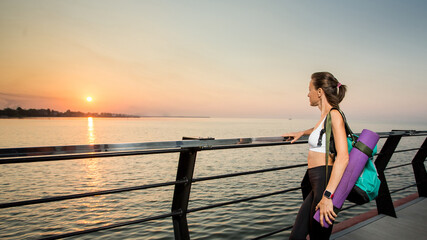 Fototapeta premium Fitness sport model in fashion sportswear with sunrise sky