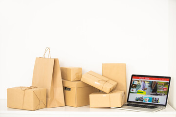 Online shopping - Paper cartons or parcel on a laptop keyboard. Shopping service on The online web and offers home delivery.