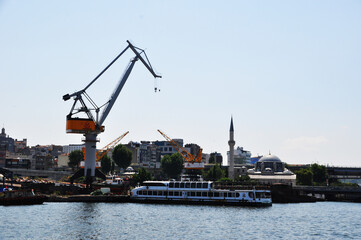 Fototapeta premium Sea port view. Cargo port with a large harbor crane. City landscape. 09 July 2021, Istanbul, Turkey.