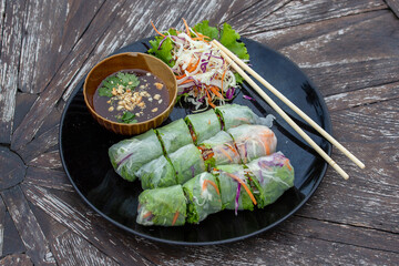 Fresh vietnamese spring rolls on a plate with salad