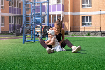 mom and child walk and play in the city courtyard