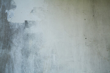 old white wall covered with dirty plaster with a visible structure