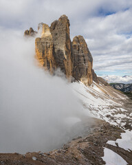 fog being held by mountains in dolomites Italy tre cime di lavaredo