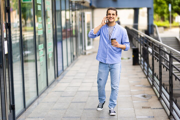 Young man talk on phone and walk on street