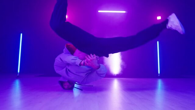 Neon lights dancer head spin breakdancing in slow motion 4K