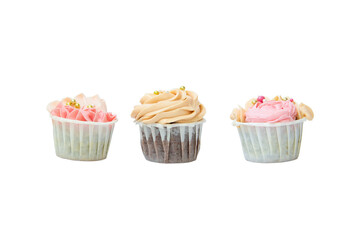 Three cupcakes with butter cream. Isolated on white background.