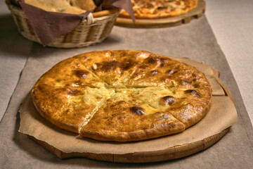 Ruddy closed pizza on a wooden tray