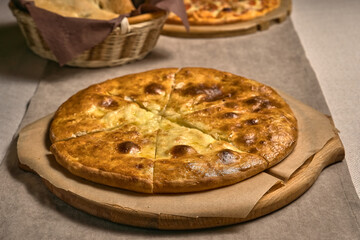 Ruddy closed pizza on a wooden tray