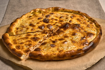 Ruddy closed pizza on a wooden tray