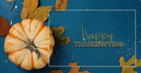 Fall rustic backdrop with mini pumpkin on blue background for Thanksgiving holiday graphic.