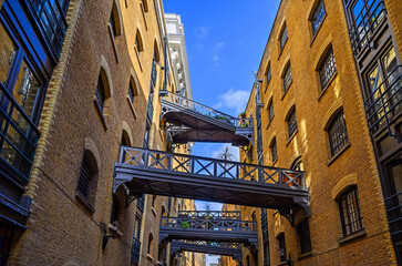 Shad Thames in London, UK. Historic Shad Thames is an old cobbled street known for it's restored overhead bridges and walkways. This old street is in Bermondsey near Tower Bridge and London Bridge.