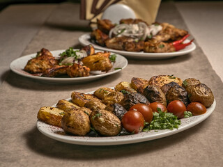 Baked potatoes and vegetables with herbs