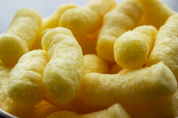homemade wafer rolls lie on a brown plate on the grass. next to a snow-white napkin. dessert on nature. sweets time