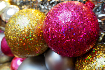 Obraz premium big shiny round gold and pink Christmas toys are hanging on the Christmas tree. side view