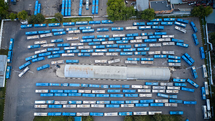 Top down aerial view directly above the abandoned trolley buses in a bus fleet or bus parking