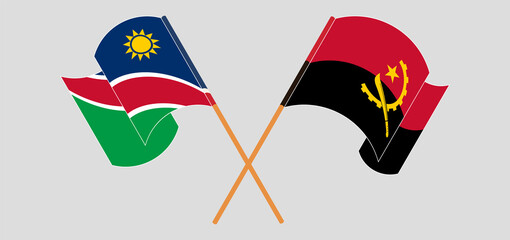Crossed and waving flags of Namibia and Angola.