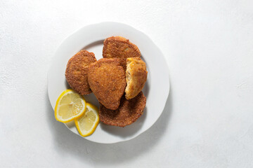 Ready fried fish caviar cutlets on a white plate, light background, flat lay