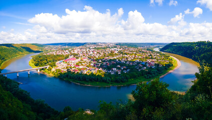City on a peninsula surrounded by a large river. Sunny summer landscape. 