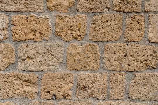Wall made with many tuff bricks. Wall of tuff stone.