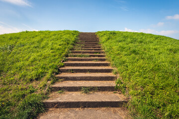 Concrete stairs to the top of a Dutch dike. The photo was taken near the village of Scherpenisse on the former island of Tholen, province of Zeeland. Behind the dike is the Oosterschelde estuary.
