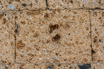 Wall made with many tuff bricks. Wall of tuff stone.