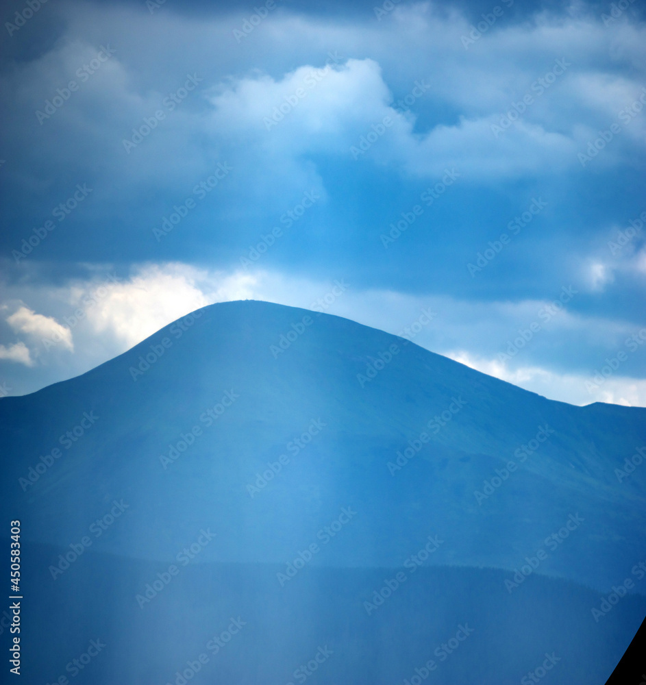 Wall mural sun rays and rain in the carpathian mountains in summer
