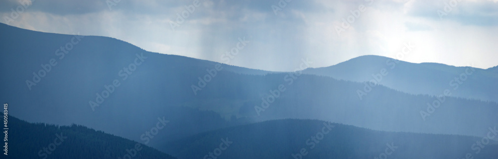 Wall mural sun rays and rain in the carpathian mountains in summer