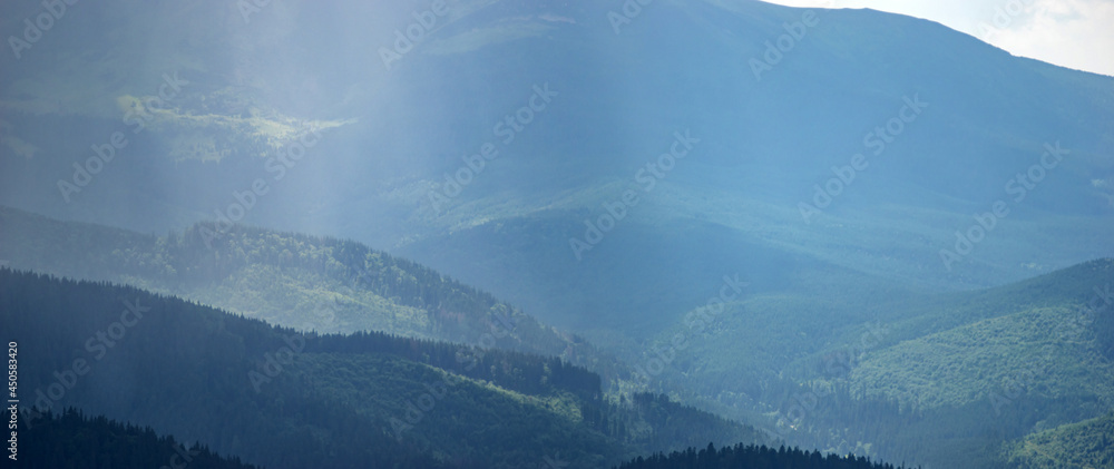 Wall mural sun rays and rain in the carpathian mountains in summer