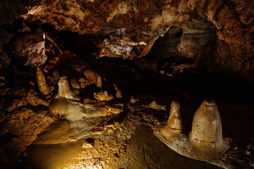 Koneprusy, Czech Republic, 24 July 2021: Natural dripstone rock formations with stone decoration in Koneprusy limestone caves in Bohemian Karst, underground world with stalagmite and stalactite halls