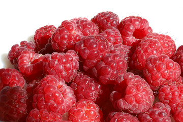 Handful of ripe fresh raspberry berries on white background