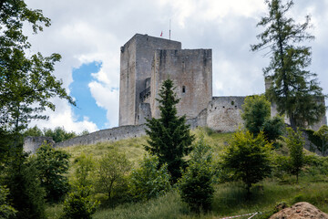 Fototapeta na wymiar Landstejn, South Bohemian, Czech Republic, 03 July 2021: medieval knights ancient ruins of Romanesque and gothic castle at sunny summer day, Stone wall standing on green hill, Forest scenic landscape