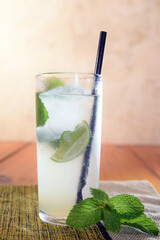 Frozen Margarita mixed drink with lime slice on plain background close up