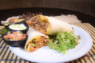 Burritos wraps with beef and vegetables on black background. Beef burrito, mexican food. Banner