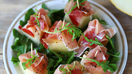 Jamon arugula melon appetizer. Healthy food. Italian Cuisine.