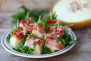 Jamon arugula melon appetizer. Healthy food. Italian Cuisine.
