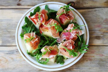 Jamon arugula melon appetizer. Healthy food. Italian Cuisine.