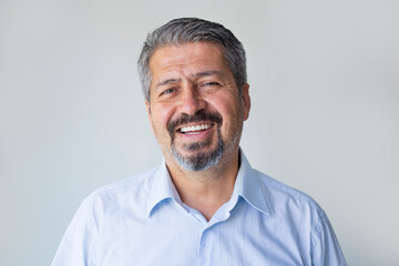 Portrait elderly man with candid wide smile looking at camera