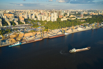 Aerial view of the river port and urban sprawl on the background