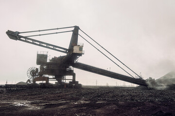 Bucket wheel excavator - a mining transport vehicle on a walking-rail track. Big overburden machine.