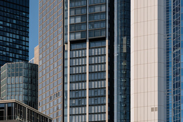 Obraz premium Exterior architectural detail modern facade of High-rise office buildings. Abstract Urban metropolis background.