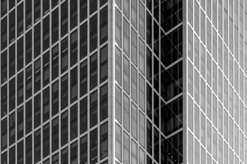 Fototapeta na wymiar Black and white tone, Exterior architectural detail modern facade of High-rise office buildings. Abstract Urban metropolis background.