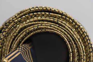 intricate but visually attractive navy blue and gold ribbon close up